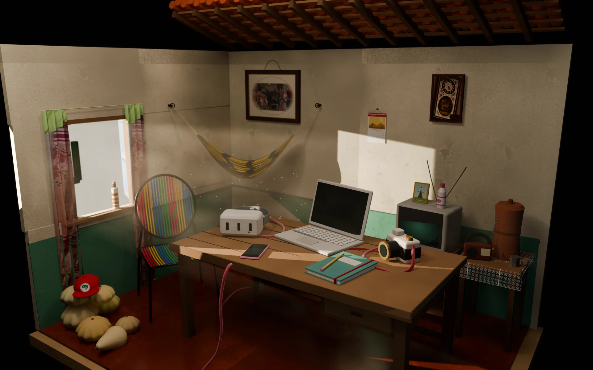 Cardboard model of a house in the interior of Ceará: clay tile roof, a hammock, a woven chair, a family portrait, an old TV and a radio. On the table, a notebook, a camera, a phone, a laptop and a VR headset.